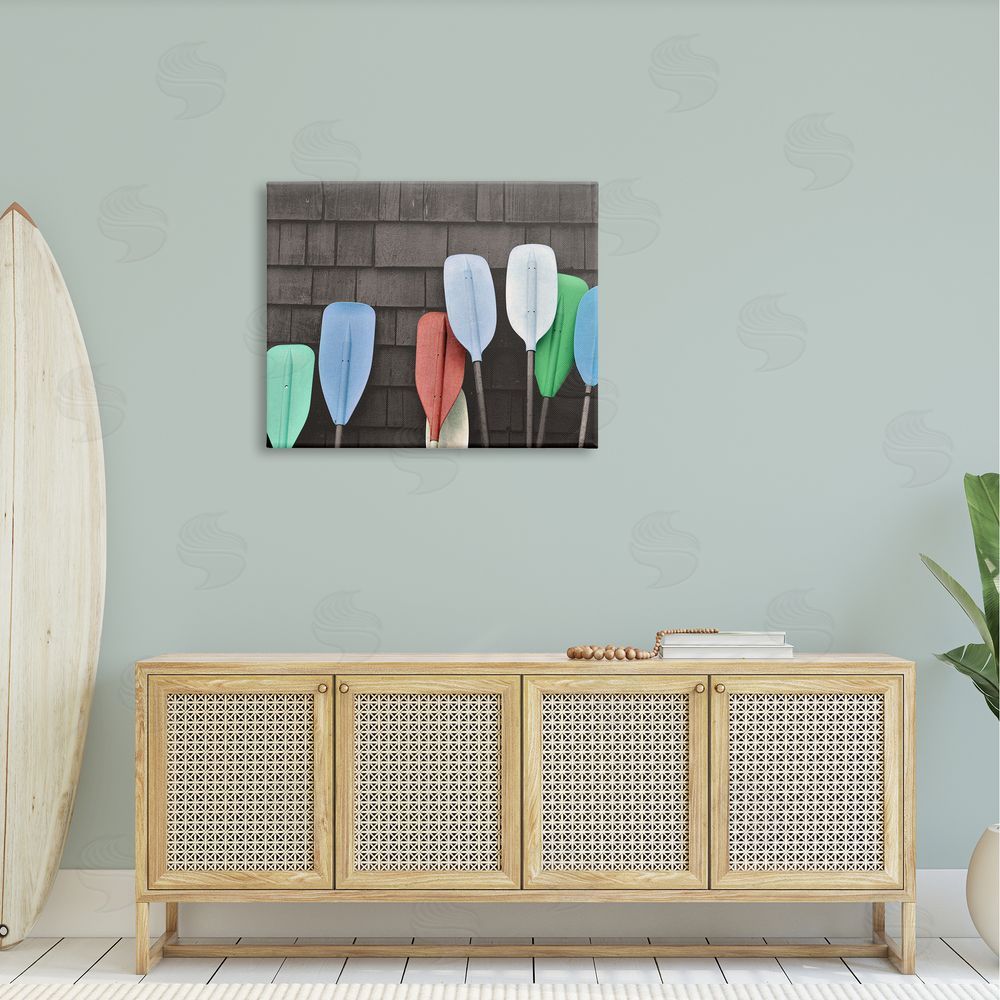 Stupell Studio Mixed Ores Against Beach Shed Boating Paddle Canvas Wall Art Print in Room